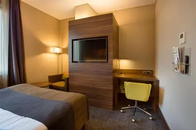 a hotel room with a bed and a desk and a tv at Holiday Inn Istanbul - Kadikoy by IHG in Istanbul