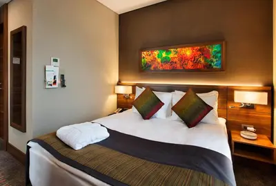 a hotel room with a large bed with pillows at Holiday Inn Istanbul - Kadikoy by IHG in Istanbul