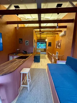 a living room with a bar and a kitchen at Historic Design 3-Storey Arnavutköy Home with Patio in Istanbul