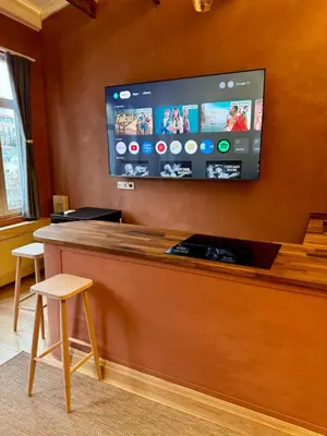 a bar with a flat screen tv on a wall at Historic Design 3-Storey Arnavutköy Home with Patio in Istanbul