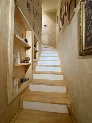 a staircase in a house with wooden steps at Historic Design 3-Storey Arnavutköy Home with Patio in Istanbul