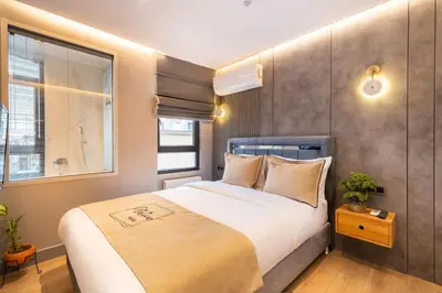 a bedroom with a large bed and a window at İstanbul Platine Apartment in Taksim
