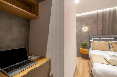 a bedroom with a laptop on a desk next to a bed at İstanbul Platine Apartment in Taksim