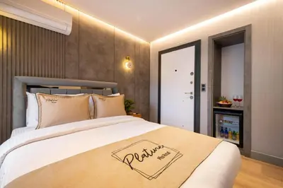 a bedroom with a large bed with a sign on it at İstanbul Platine Apartment in Taksim