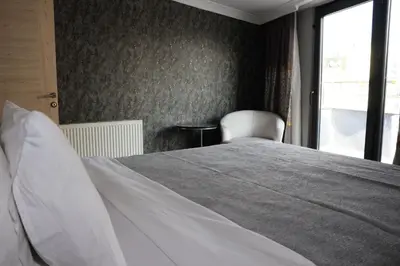 a bedroom with a white bed and a window at DT Suites in Istanbul