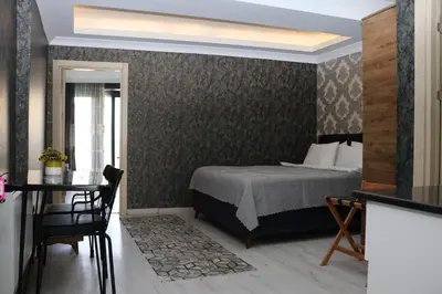 a bedroom with a bed and a table and a dining room at DT Suites in Istanbul