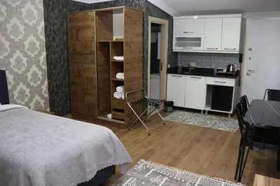 a room with a bed and a kitchen with a counter at DT Suites in Istanbul