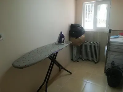 a bed in a room with a ironing board at La Casa25 in Istanbul