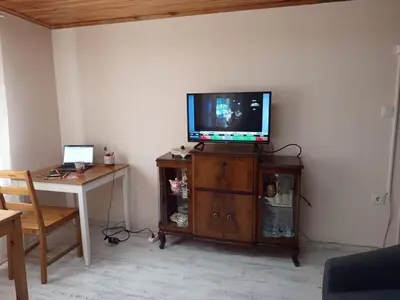 a living room with a television on a wooden cabinet at La Casa25 in Istanbul