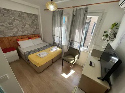 a small bedroom with a bed and a chair at The Rodin Taksim in Istanbul