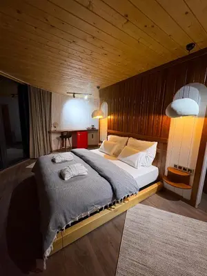 a bedroom with a large bed in a wooden room at Dream River Sapanca in Sapanca