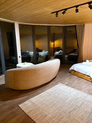 a living room with a large couch and a bed at Dream River Sapanca in Sapanca