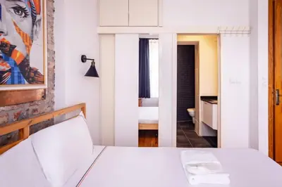 a bedroom with a white bed and a bathroom at Authentic Galata Tower Central 2BD2Bath Home #411 in Istanbul