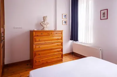 a bedroom with a dresser with a statue on it at Authentic Galata Tower Central 2BD2Bath Home #411 in Istanbul