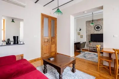 a living room with a red couch and a table at Galata Tower 2BD2Bath Authentic Gem! #412 in Istanbul