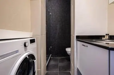 a washing machine in a bathroom with a toilet at Galata Tower 2BD2Bath Authentic Gem! #412 in Istanbul