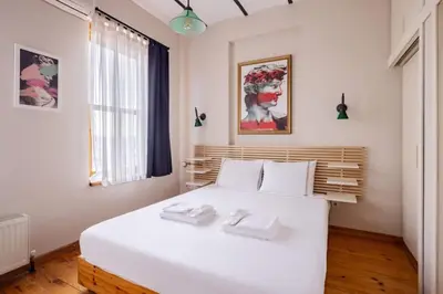 a bedroom with a white bed with two towels on it at Cool Authentic 2BD2Bath Galata Tower Home! #413 in Istanbul