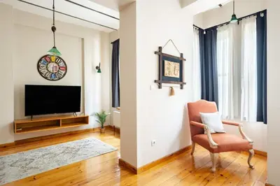 a living room with a television and a chair at Cool Authentic 2BD2Bath Galata Tower Home! #413 in Istanbul