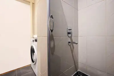 a shower stall with a washing machine in a bathroom at Cool Authentic 2BD2Bath Galata Tower Home! #413 in Istanbul