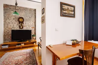 a living room with a dining room table and a brick wall at Cozy Intimate 2BD2Bath Galata Tower Home! #410 in Istanbul