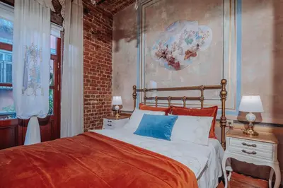 a bedroom with a bed and a brick wall at Allegory of Taksim in Istanbul