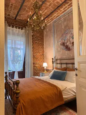 a bedroom with a bed and a brick wall at Allegory of Taksim in Istanbul