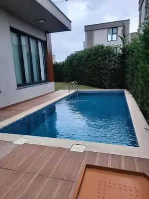 a swimming pool in the backyard of a house at Villa with private pool for daily rent in Istanbul in Buyukcekmece