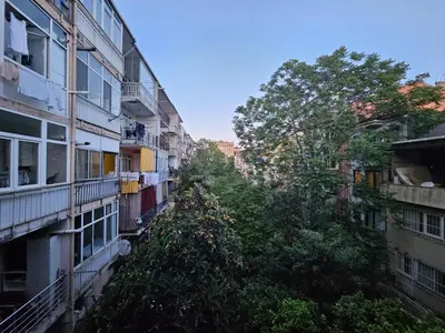 an alley between two buildings with trees at SARIKÖŞK HOTEL Kadıköy in Istanbul