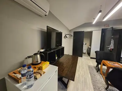 a living room with a table with water bottles on it at SARIKÖŞK HOTEL Kadıköy in Istanbul