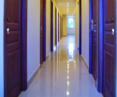 an empty hallway in a building with wooden doors at Akademik Pansiyon in Istanbul