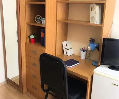 a desk with a computer and a monitor on it at Akademik Pansiyon in Istanbul