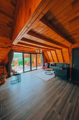 a living room with a couch and tables and windows at Sapanca Ruby Bungalow in Sapanca