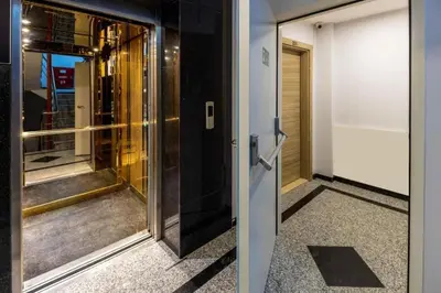 a glass door leading to an elevator in a building at Taksim Square - Apartment - Sleeps 4 - City Centre in Istanbul