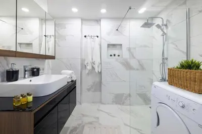a white bathroom with a sink and a shower at Taksim Square - Apartment - Sleeps 4 - City Centre in Istanbul
