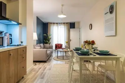a kitchen and living room with a table and chairs at Taksim Square - Apartment - Sleeps 4 - City Centre in Istanbul