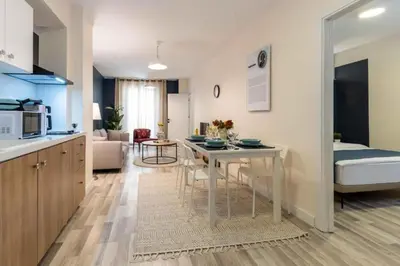 a kitchen and living room with a table and a couch at Taksim Square - Apartment - Sleeps 4 - City Centre in Istanbul