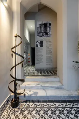 a staircase in a building with a sign on the wall at The Muradiye Luxury Apartments in Istanbul
