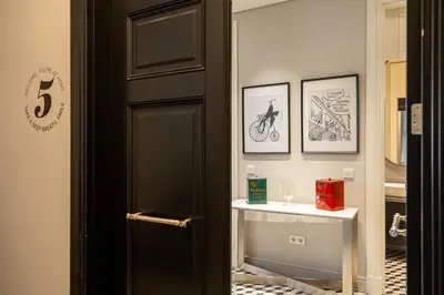 a hallway with a black door and a table at The Muradiye Luxury Apartments in Istanbul