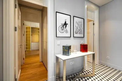 a hallway with a table and a bike on the wall at The Muradiye Luxury Apartments in Istanbul