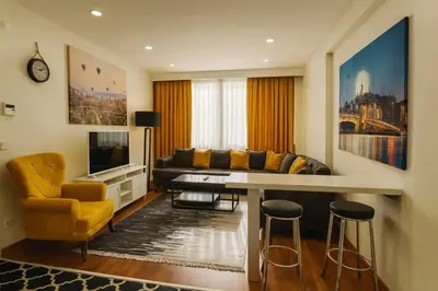 a living room with a couch and a table at Gold Suit - Bakırköy City Center in Istanbul