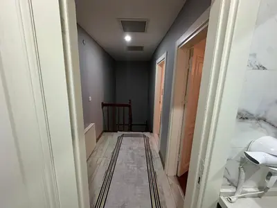 a hallway leading to a bathroom with a sink at Gold Suit - Bakırköy City Center in Istanbul