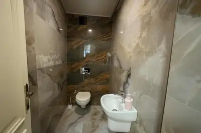 a bathroom with a toilet and a sink at Gold Suit - Bakırköy City Center in Istanbul
