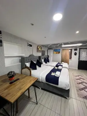 a bedroom with a large bed and a wooden table at Taksim Nova House hotel in Istanbul