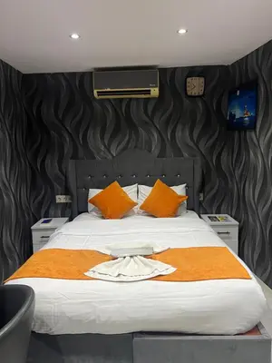 a bedroom with a large bed with orange pillows at Taksim Nova House hotel in Istanbul