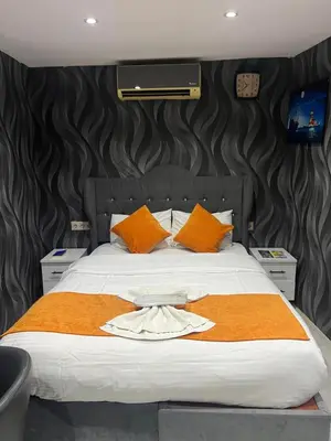 a bedroom with a large bed with orange pillows at Taksim Nova House hotel in Istanbul