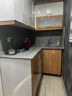 a small kitchen with white cabinets and a sink at Taksim Nova House hotel in Istanbul