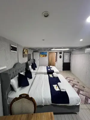 a large bedroom with two large beds in it at Taksim Nova House hotel in Istanbul