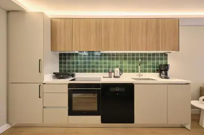a kitchen with white cabinets and a black dishwasher at BSY Flats Well Decorated Modern Apartments With 2BR, 3BR Options in Istanbul