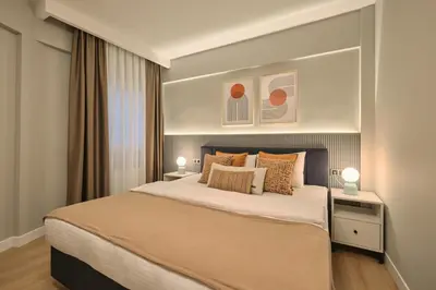 a bedroom with a large bed with two lamps at BSY Flats Well Decorated Modern Apartments With 2BR, 3BR Options in Istanbul
