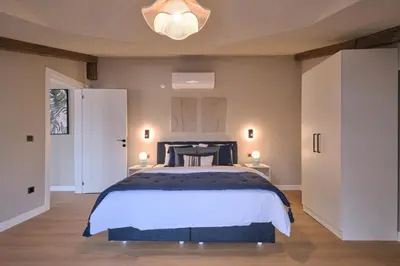 a bedroom with a large bed and a chandelier at BSY Flats Well Decorated Modern Apartments With 2BR, 3BR Options in Istanbul